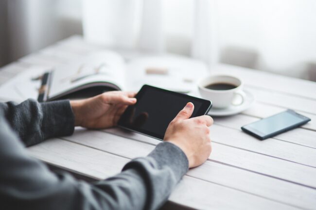 man-holds-digital-tablet-in-his-hands-6363