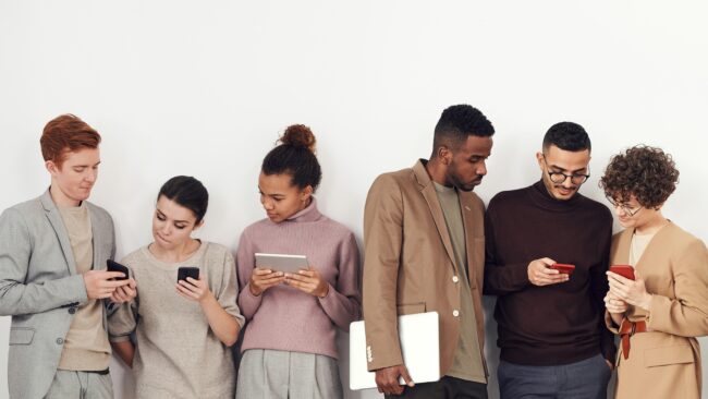 photo-of-people-standing-near-white-wall-3183180