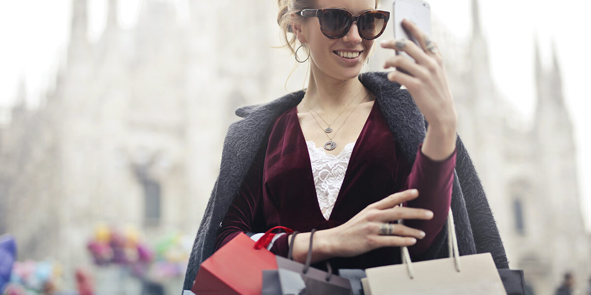 woman-in-maroon-long-sleeved-top-holding-smartphone-with-972884