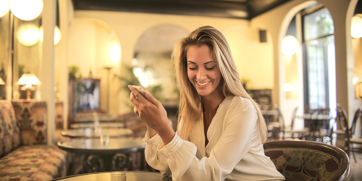 cheerful-female-having-drink-in-elegant-bar-3771833