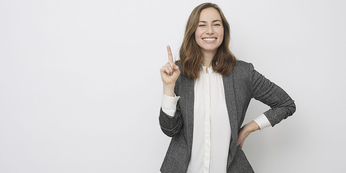 Businesswoman is pointing up while looking